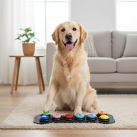 Golden retriever pressing a colorful communication button on bone-shaped mat
